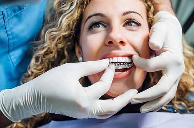 patient smiling while getting Invisalign 