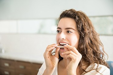 Closeup of woman removing her aligner