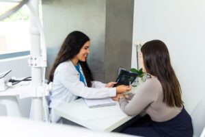 Dentist and patient reviewing X-ray together